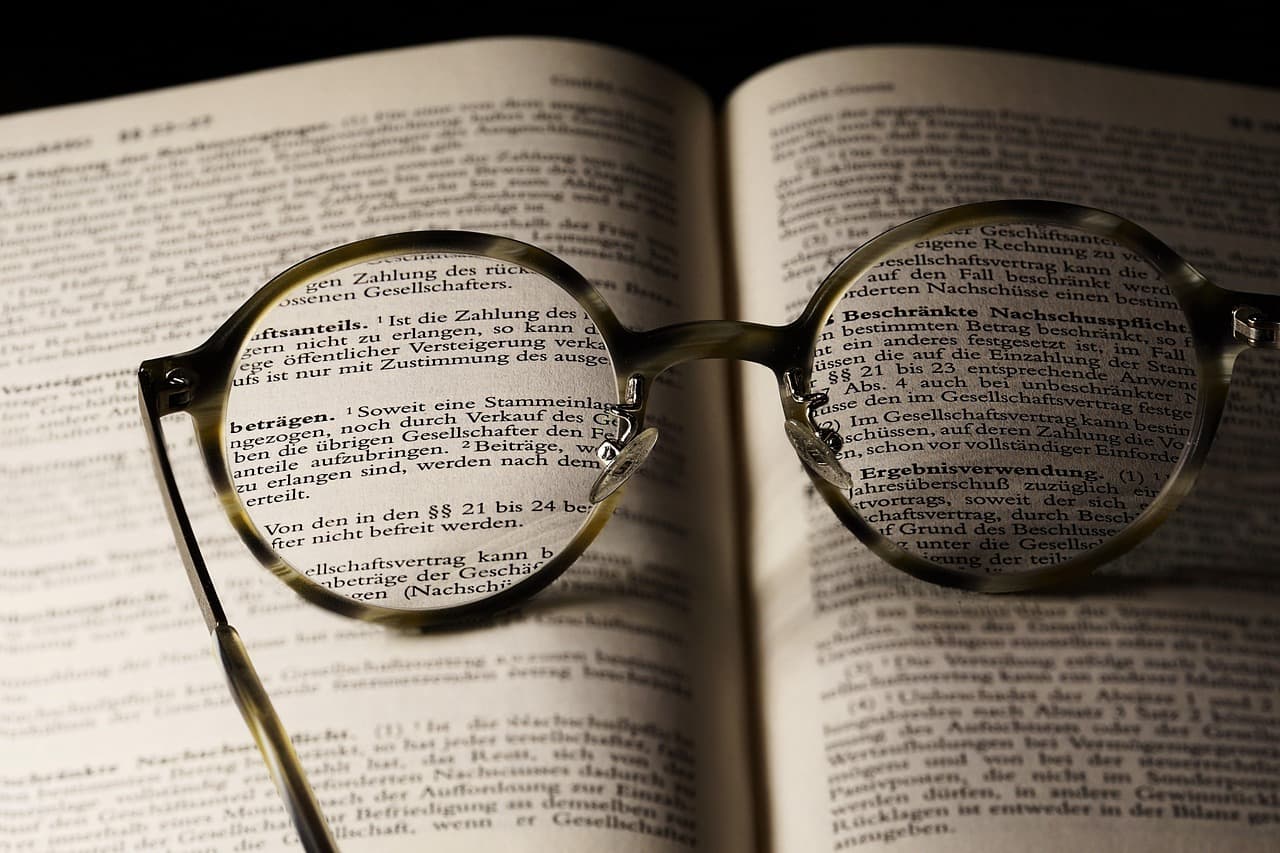 Reading glasses lying open on a book